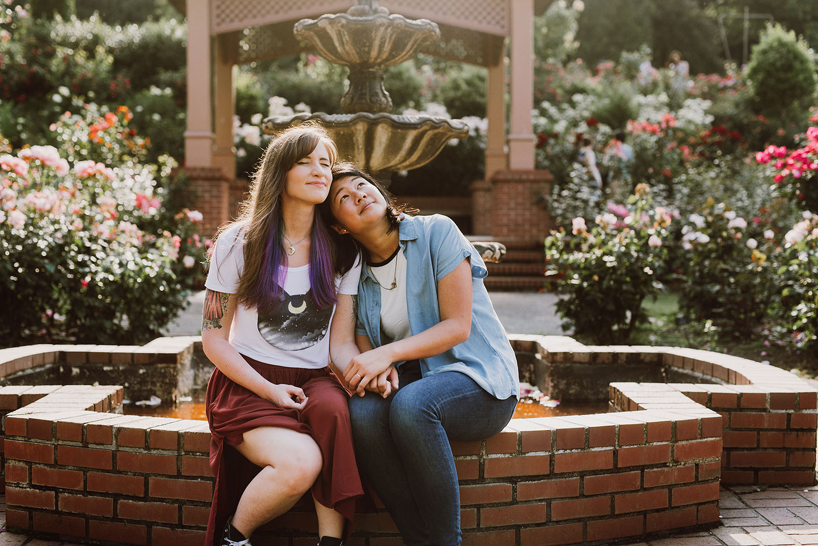 Same sex couple sitting down on a fountain - Portland Japanese Garden Proposal