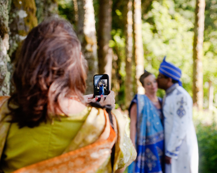 Female Guest in Sari takes iPhone photo of Bride and Groom - Bridal Veil Lakes wedding - Portland Oregon