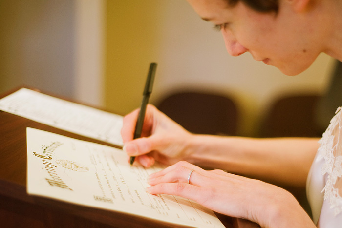 Multnomah County Court House Wedding: Bride signing documents