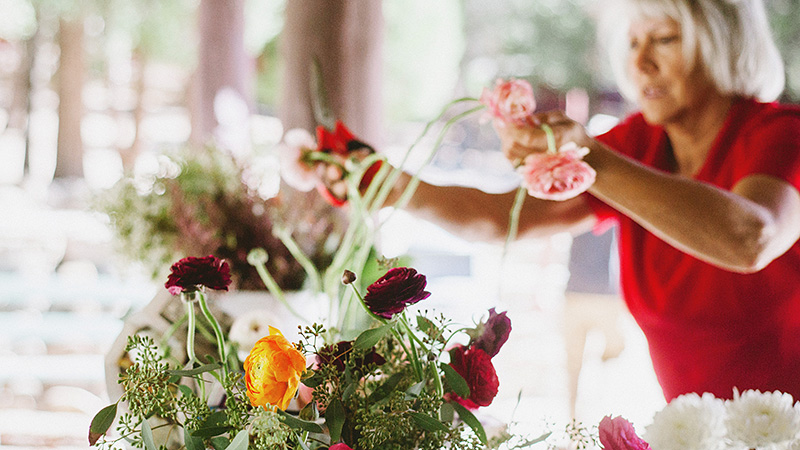 Bride's grandmother arranging flowers | Kate & Will's Camp Seely Wedding | Kim Smith-Miller