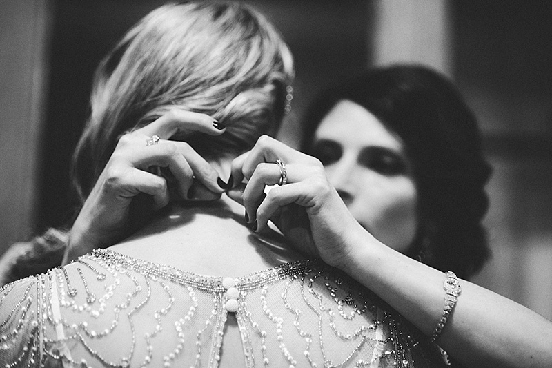 Bride’s sister putting on necklace - Sodo Park Wedding Photographer