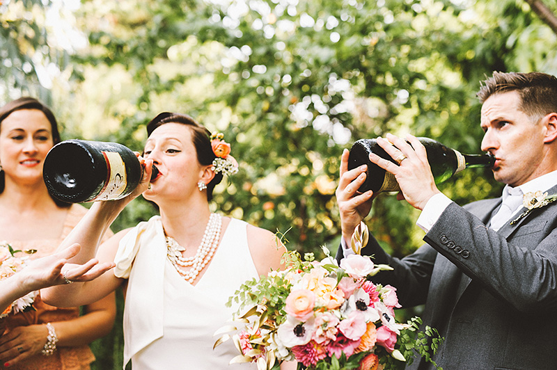 Bride and Groom chugging champagne at their Secret Society Wedding