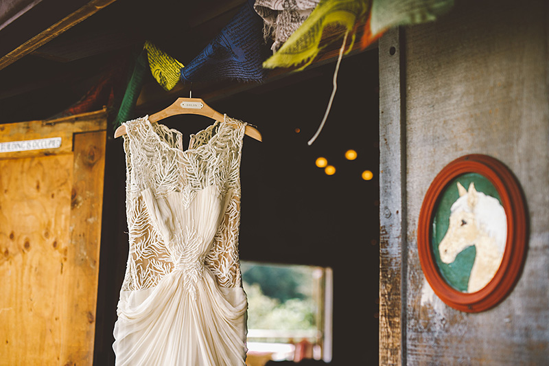 Bride's dress hanging in the Lucky Barn - Pendarvis Farm Wedding
