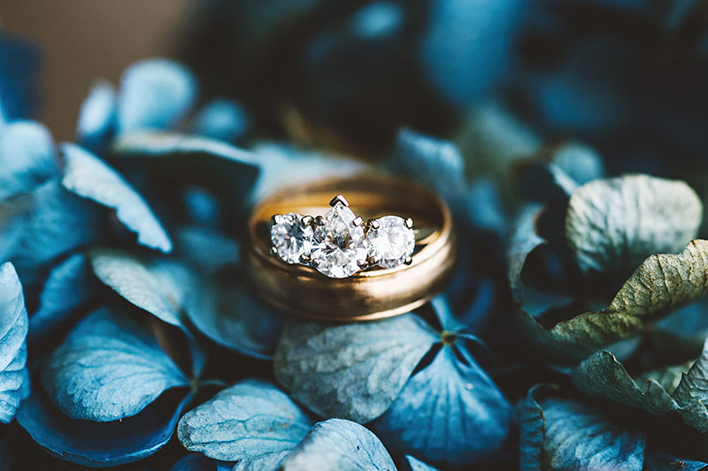 Bride and Groom's rings on a bouquet of hydrangeas - Rustic Postlewait's Wedding in Canby, OR