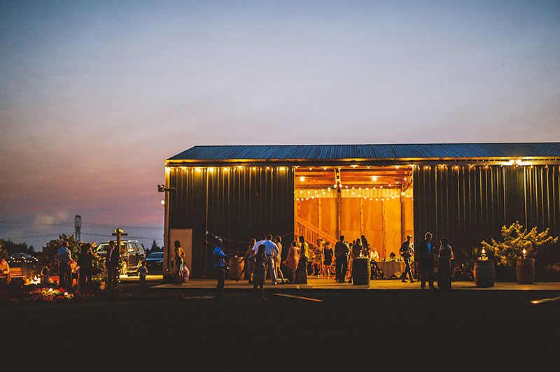 Exterior shot of the venue at night time - Rustic Postlewait's Wedding in Canby, OR