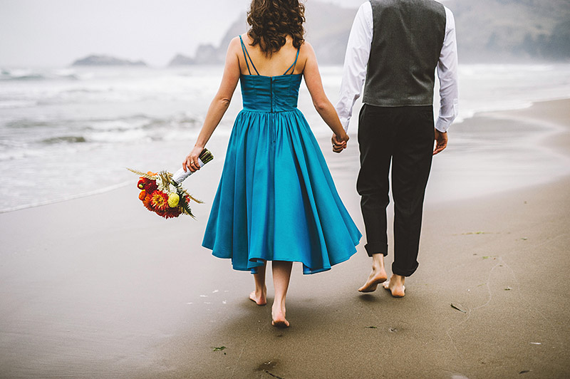 Walking on the beach at their Camp Westwind wedding