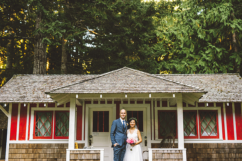 Bride and Groom in front of cabins at a Nature Bridge Wedding