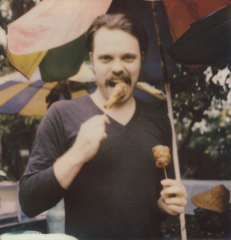 Miles eating meat on a stick in Chiang Mai | SLR680 Polaroid