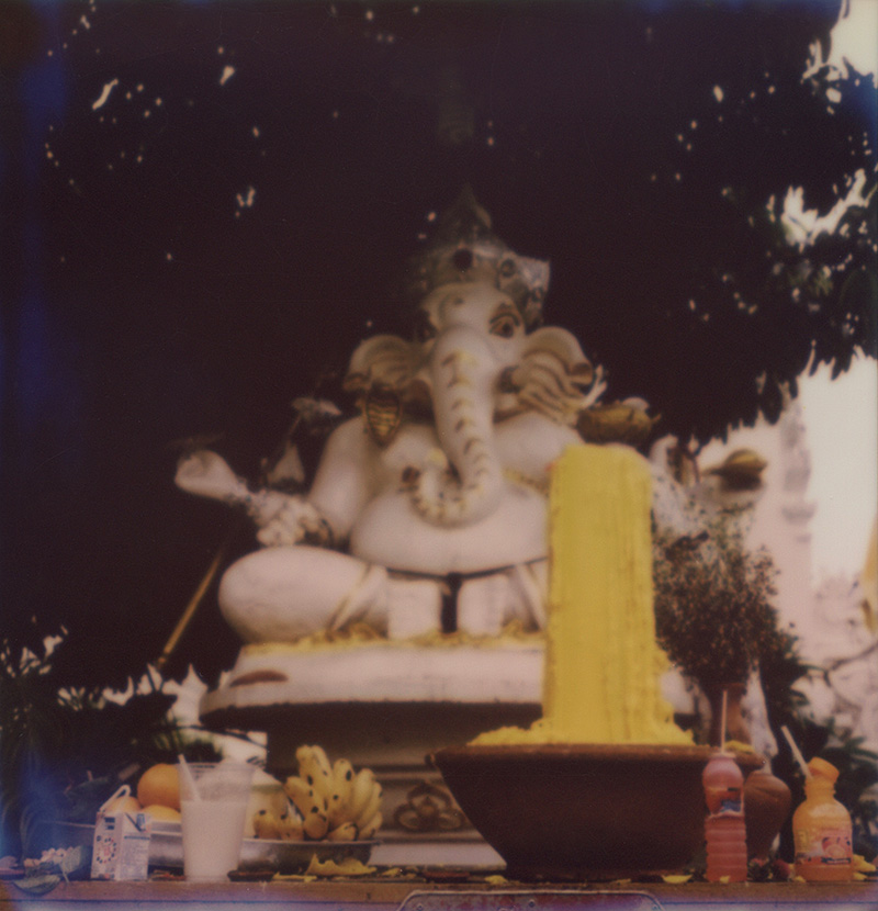 Offerings in front of a Ganesh statue in Thailand | SLR680 Polaroid