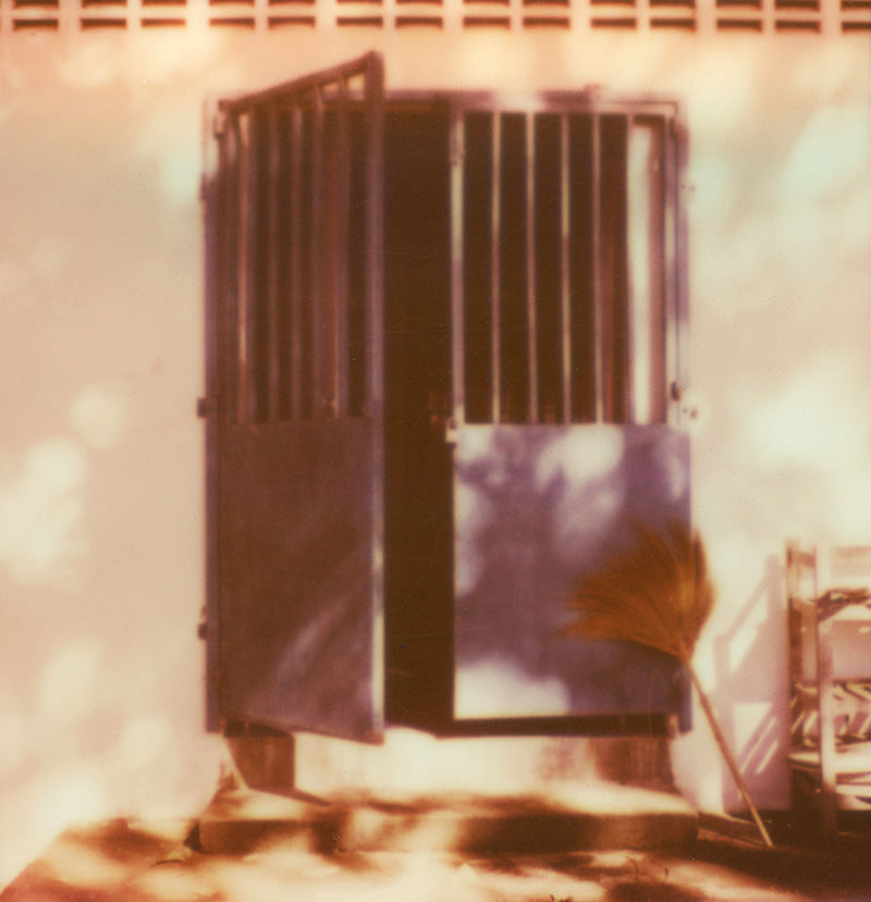 Brooms and an open door at a wat in Thailand | SLR680 Polaroid
