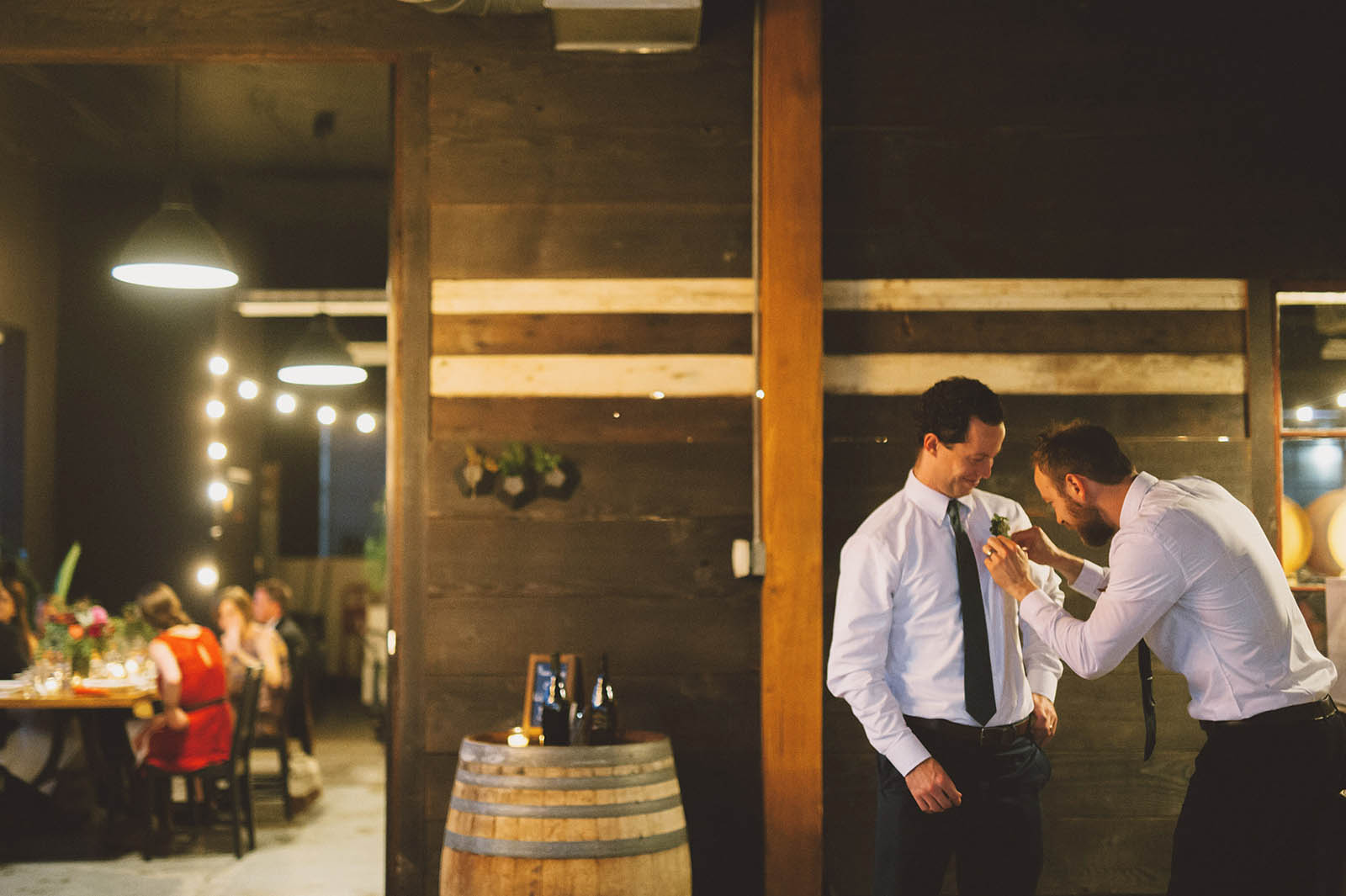 Groomsmen adjusting their boutonnieres | Clay Pigeon Winery Wedding