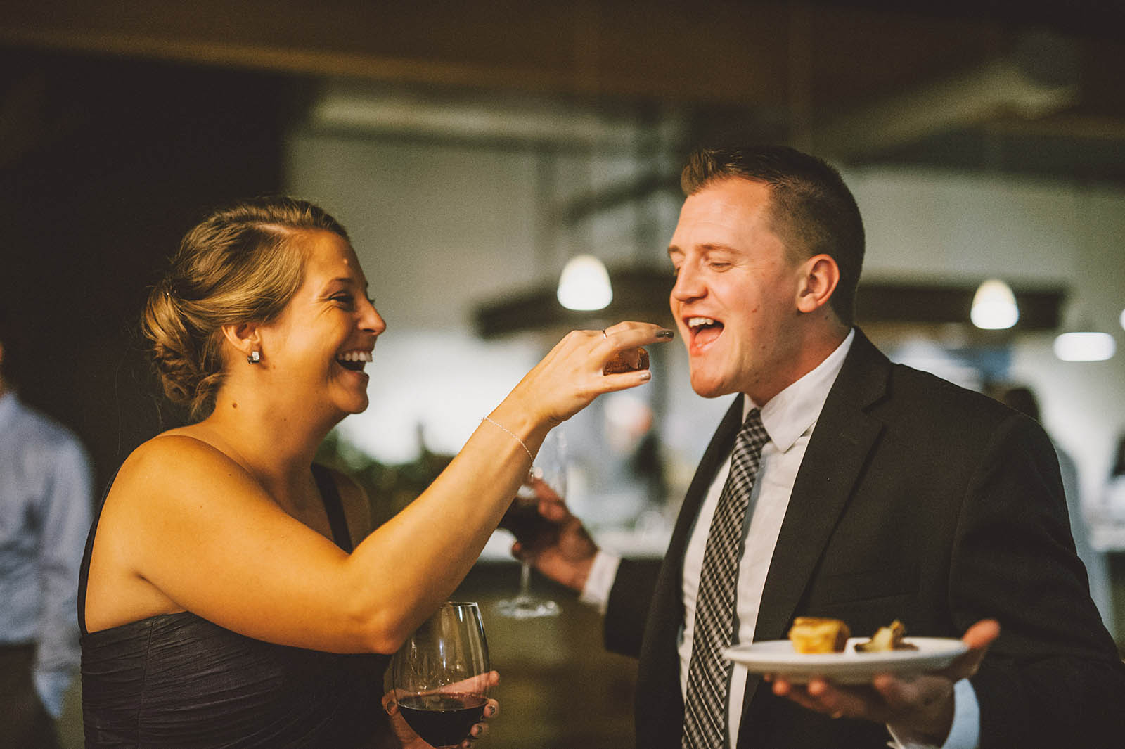 Bridesmaid feeding doughnuts to a guest | Clay Pigeon Winery Wedding