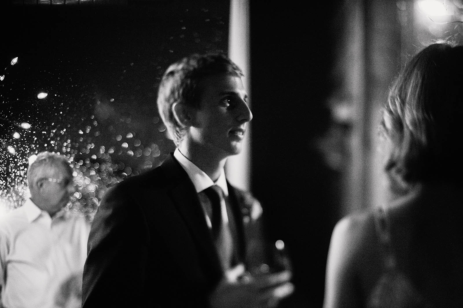Groom chatting with guests at a Clay Pigeon Winery wedding reception