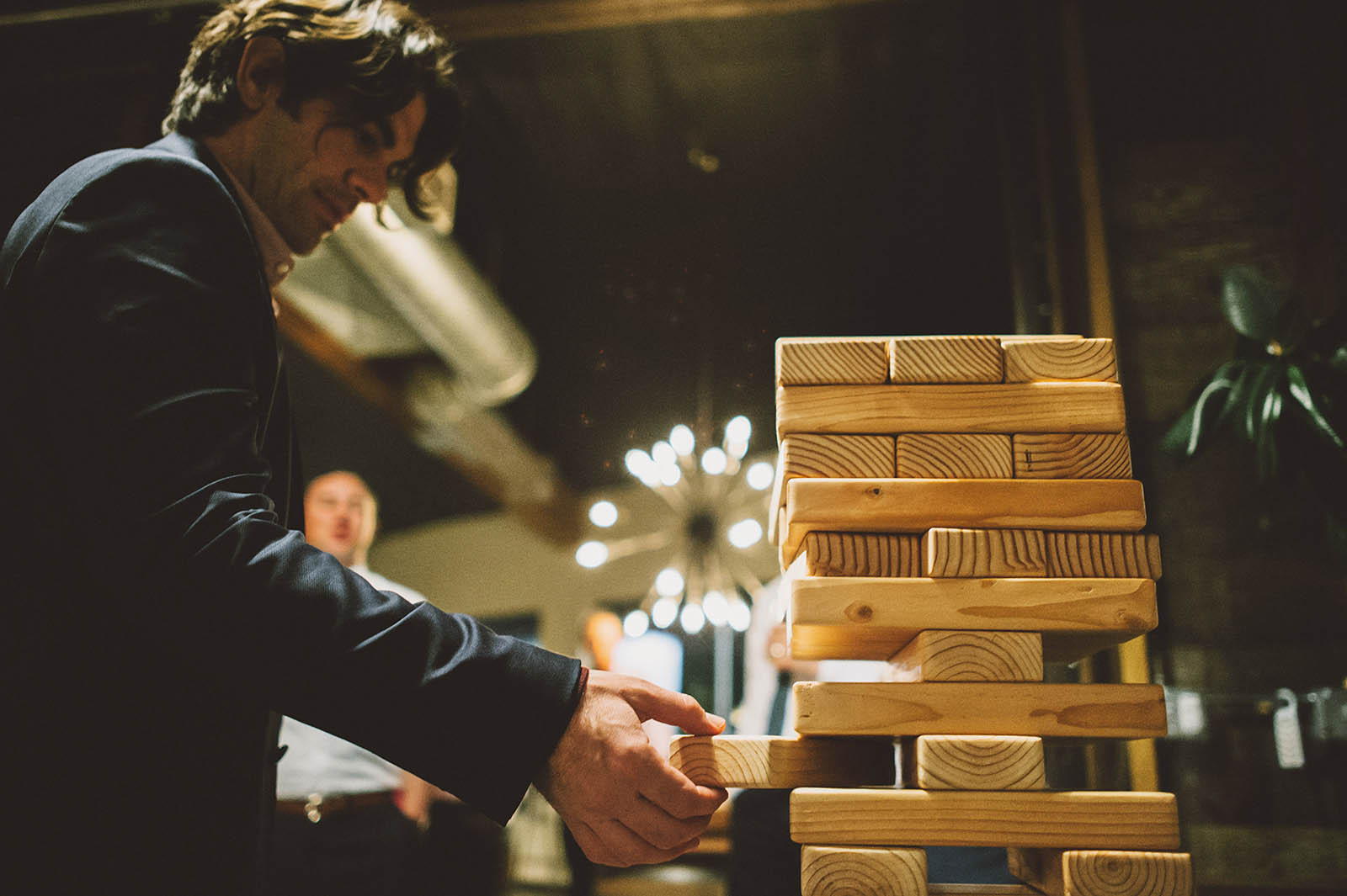 Guests playing giant Jenga at a Clay Pigeon Winery wedding reception