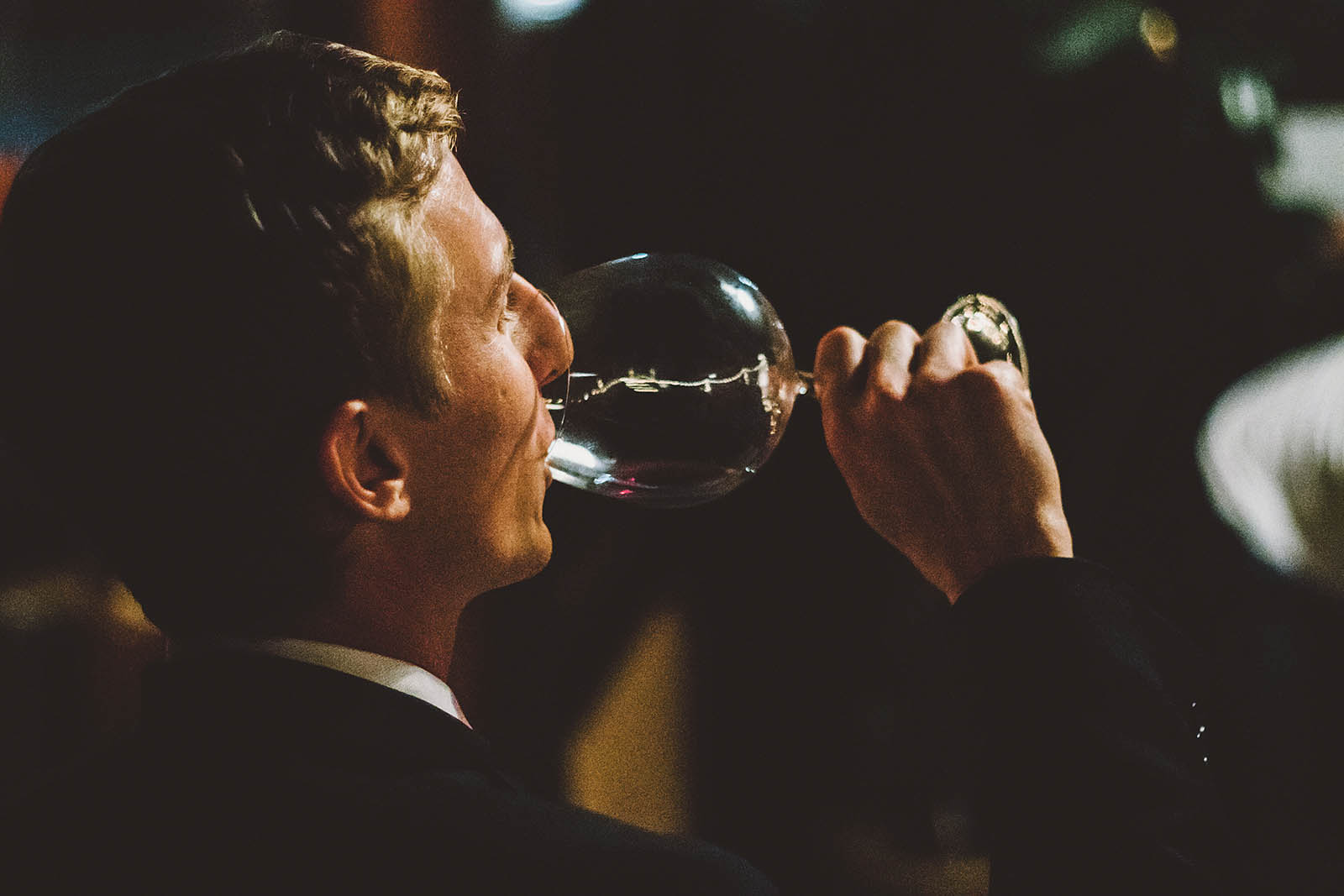 Groom drinking wine at a Clay Pigeon Winery wedding reception
