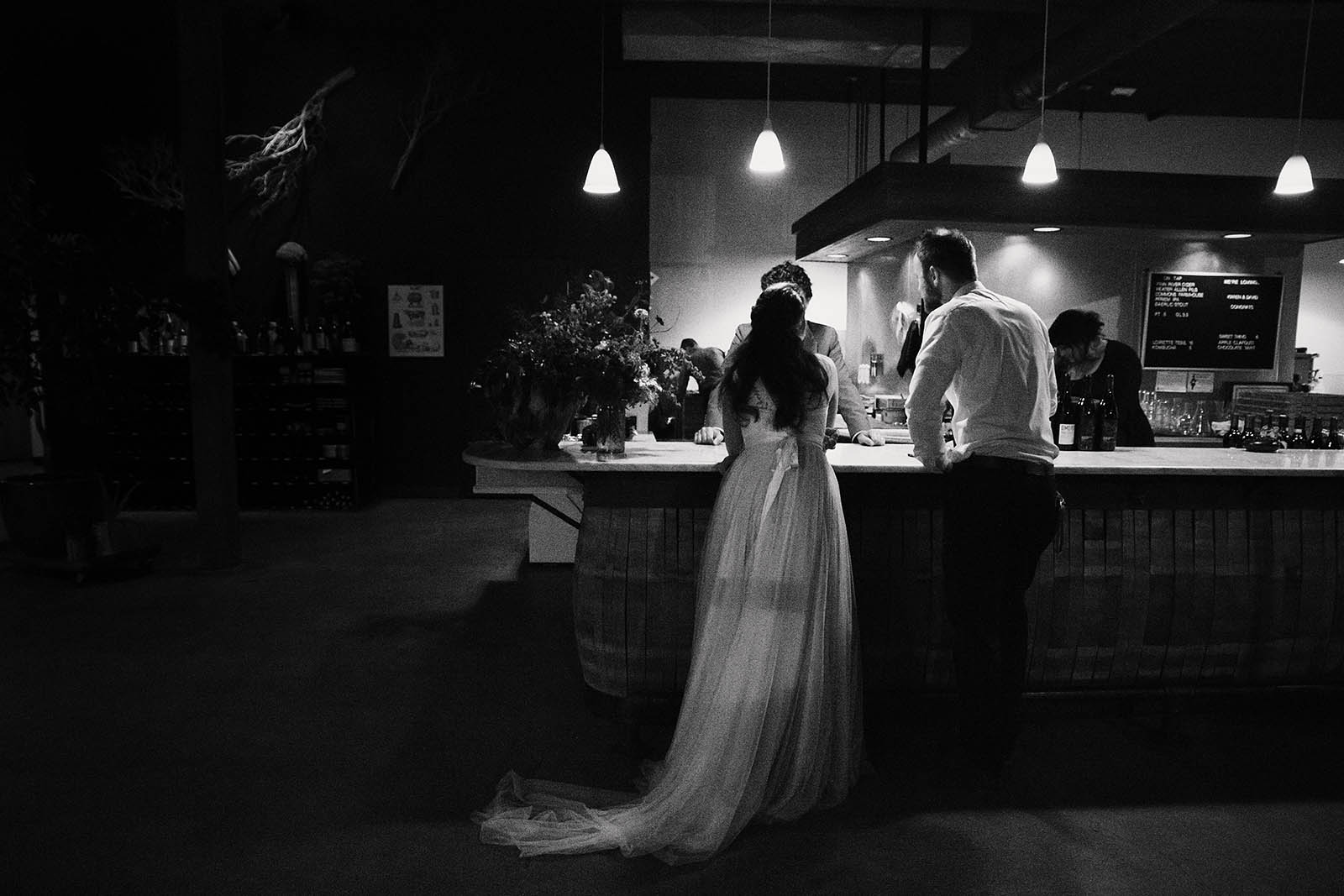 Bride and groomsmen at the bar | Clay Pigeon Winery wedding