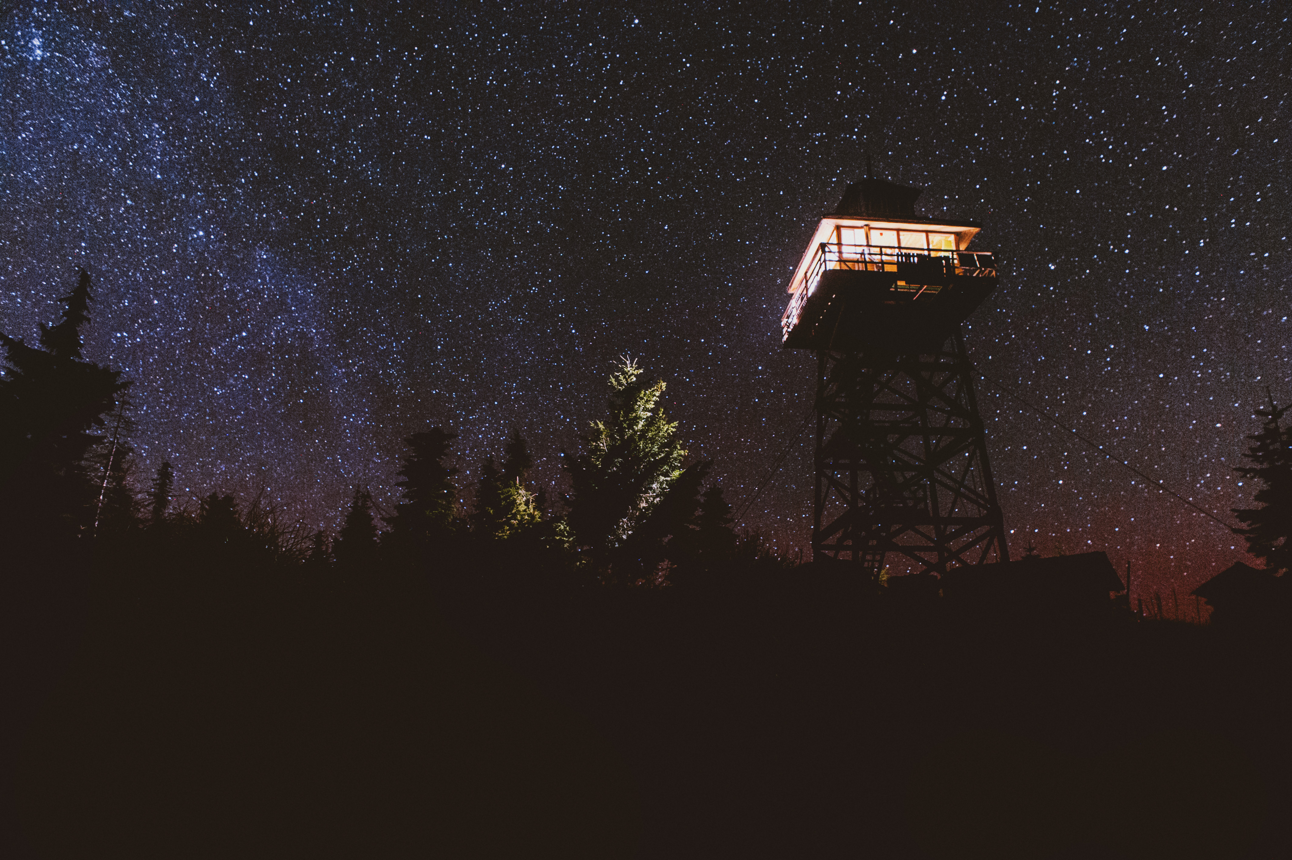 Warner Mountain Lookout Tower in front of a starry night sky