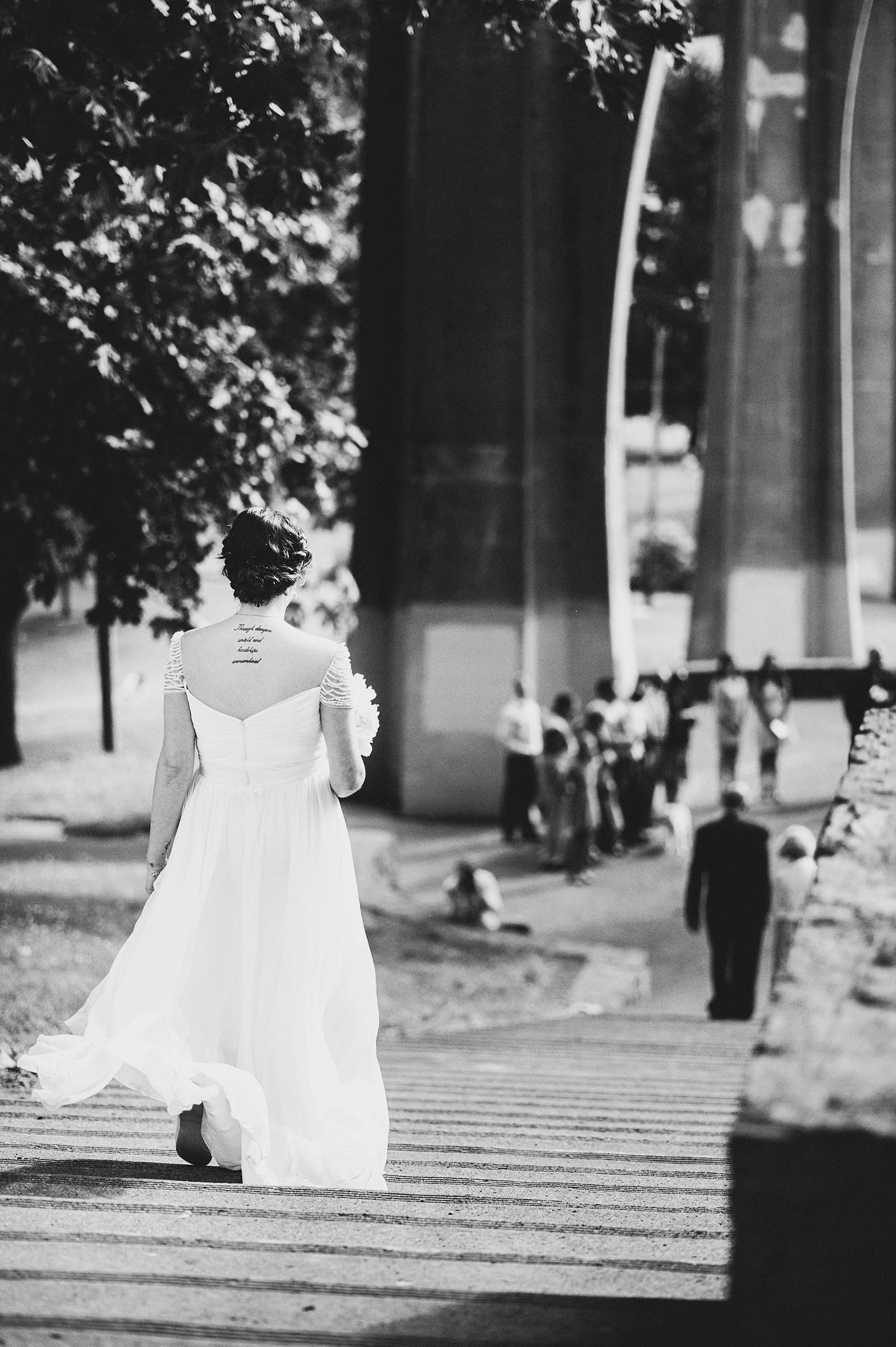 Bride walking down the steps during the ceremony | Cathedral Park Wedding