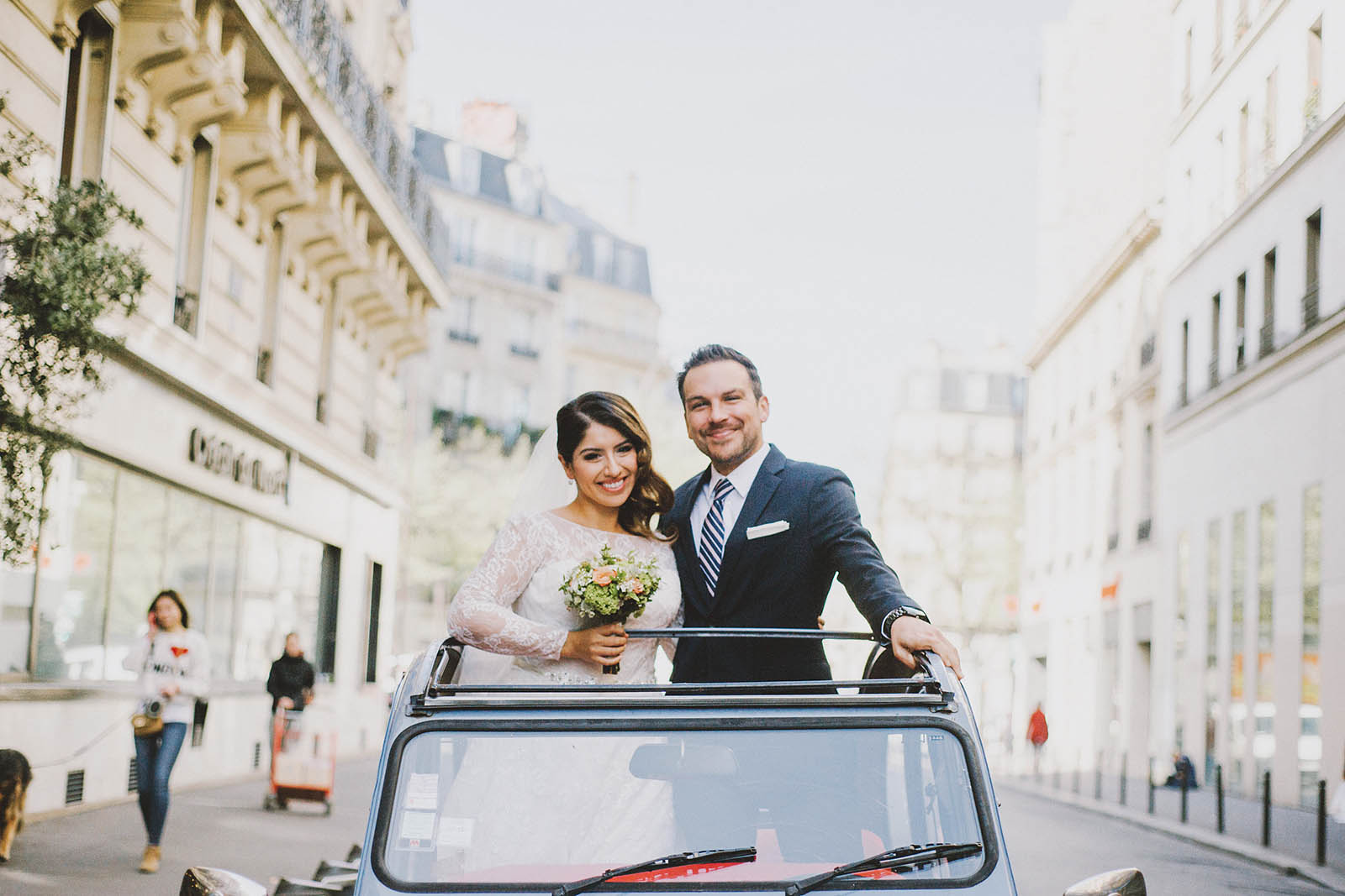 Bride and Groom riding in a 2CV | Springtime Paris Elopement at Parc des Buttes Chaumont