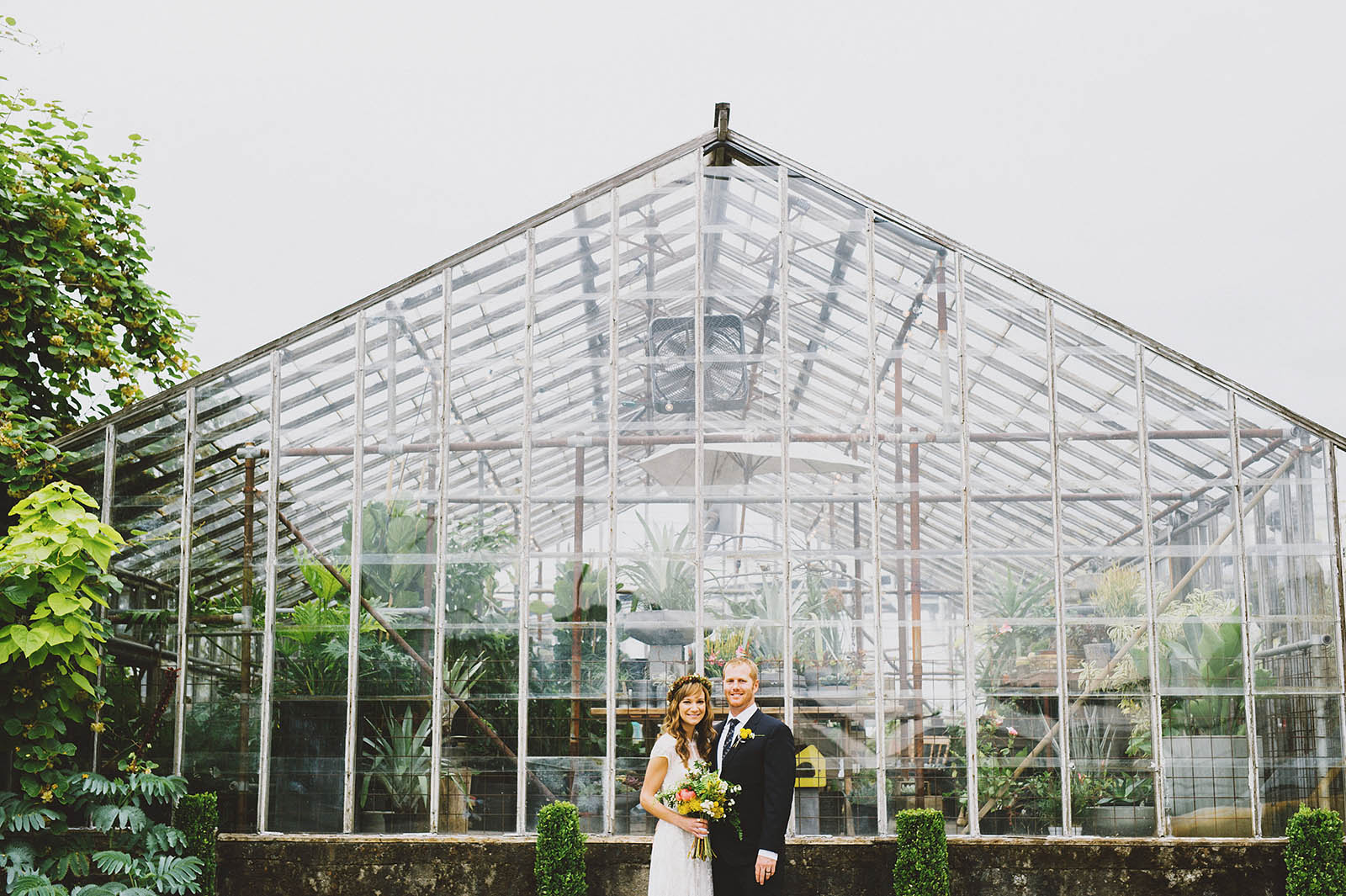 Portrait of bride and groom in front of greenhouse | Castaway Portland Wedding