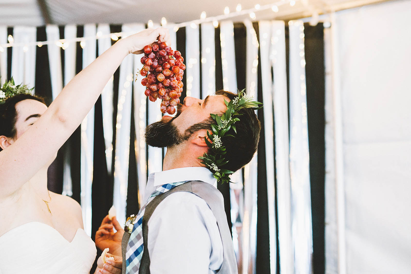 Feeding the groom grapes | SouWester Lodge Wedding