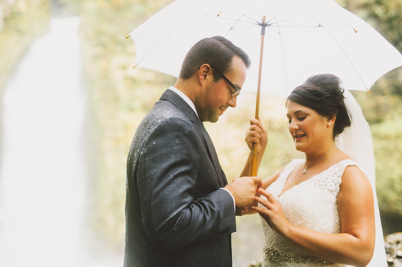 Groom putting ring on Bride's finger | Wahclella Falls Elopement