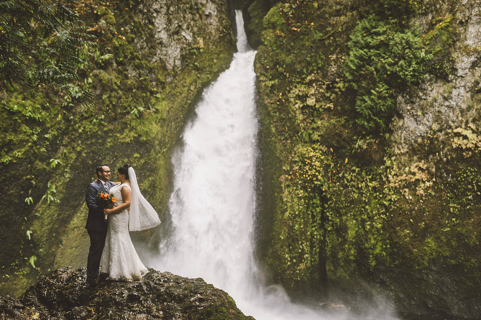 Portrait of Bride and Groom at the waterfall base | Wahclella Falls Elopement