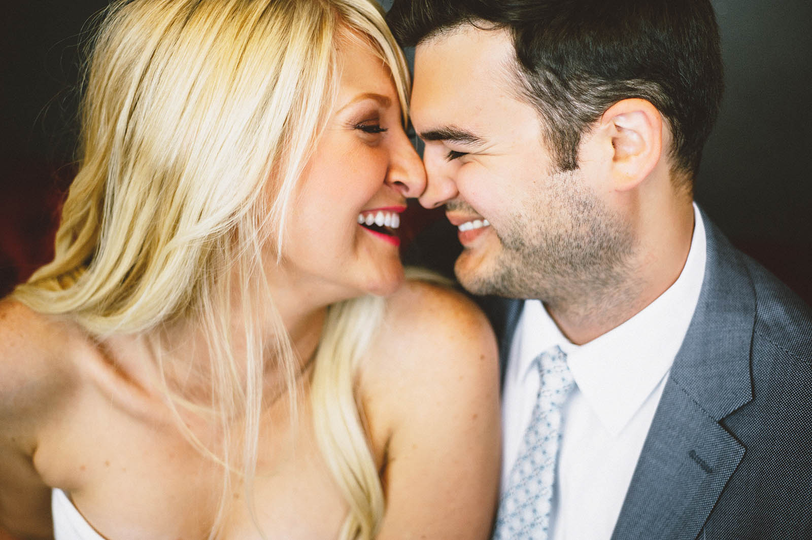Couple snuggling on couches at the Mystic Hotel | San Francisco City Hall Wedding