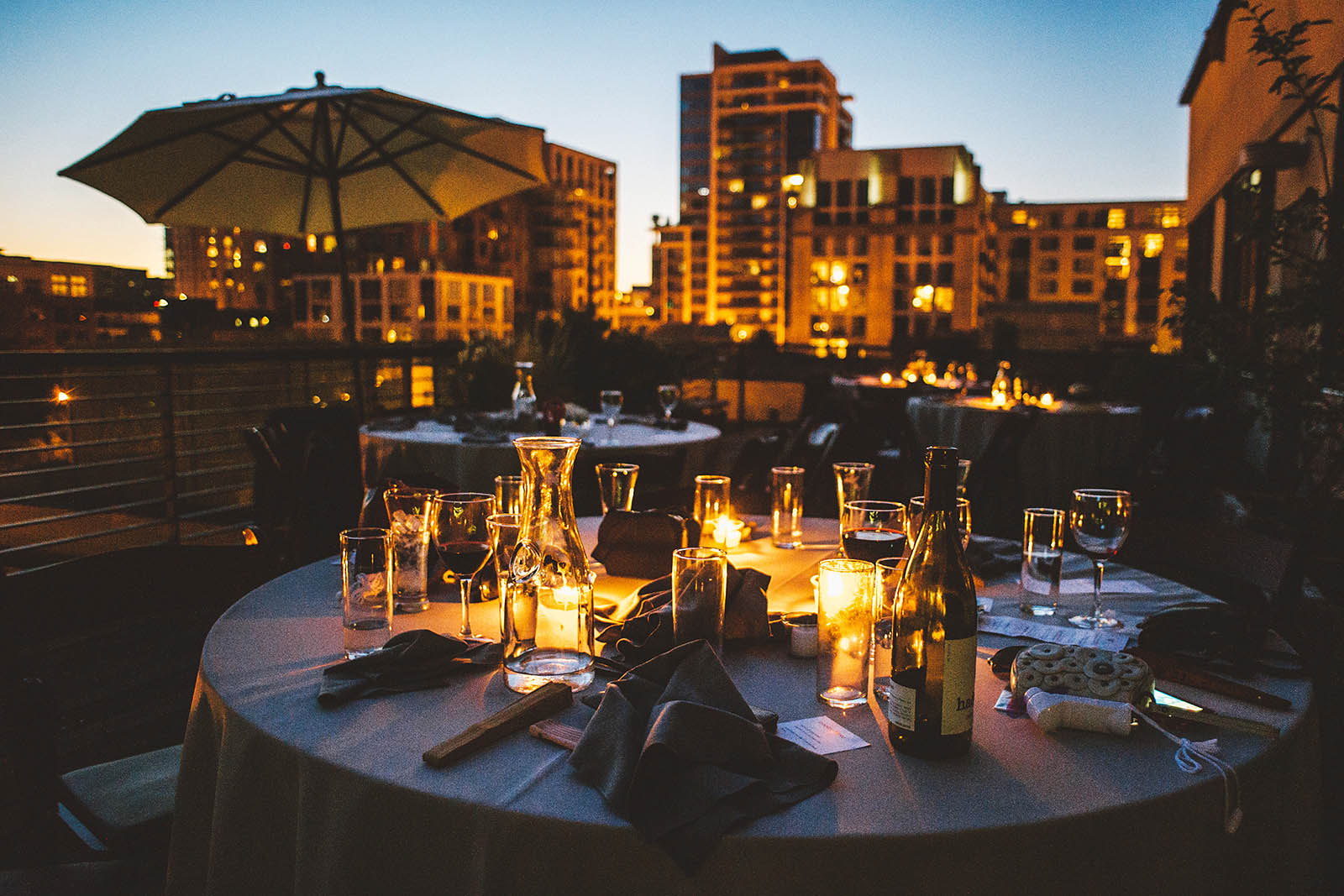 Reception tables at sunset | Ecotrust Rooftop Wedding in Downtown PDX