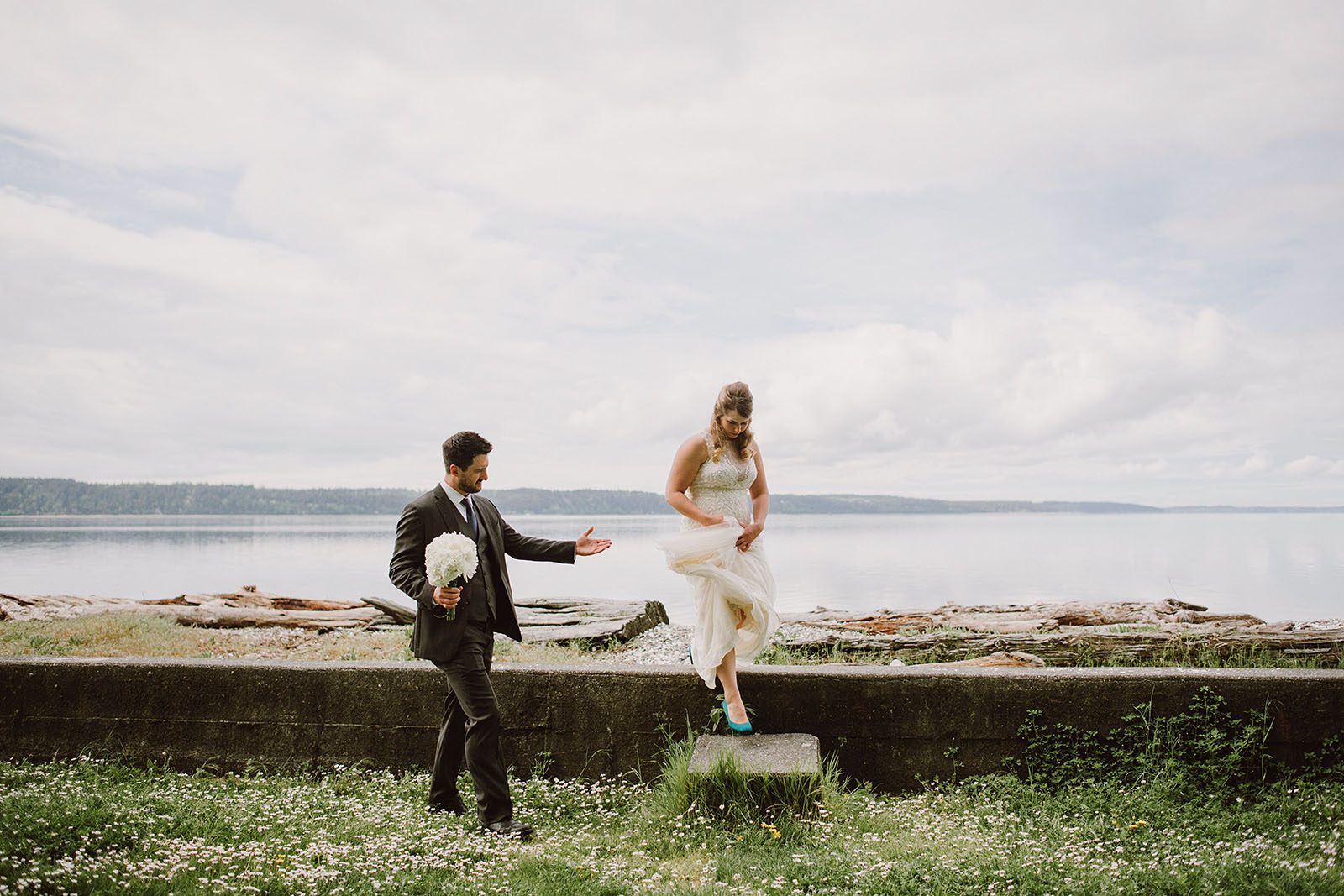 Groom helping bride down the steps | Camano Island Wedding
