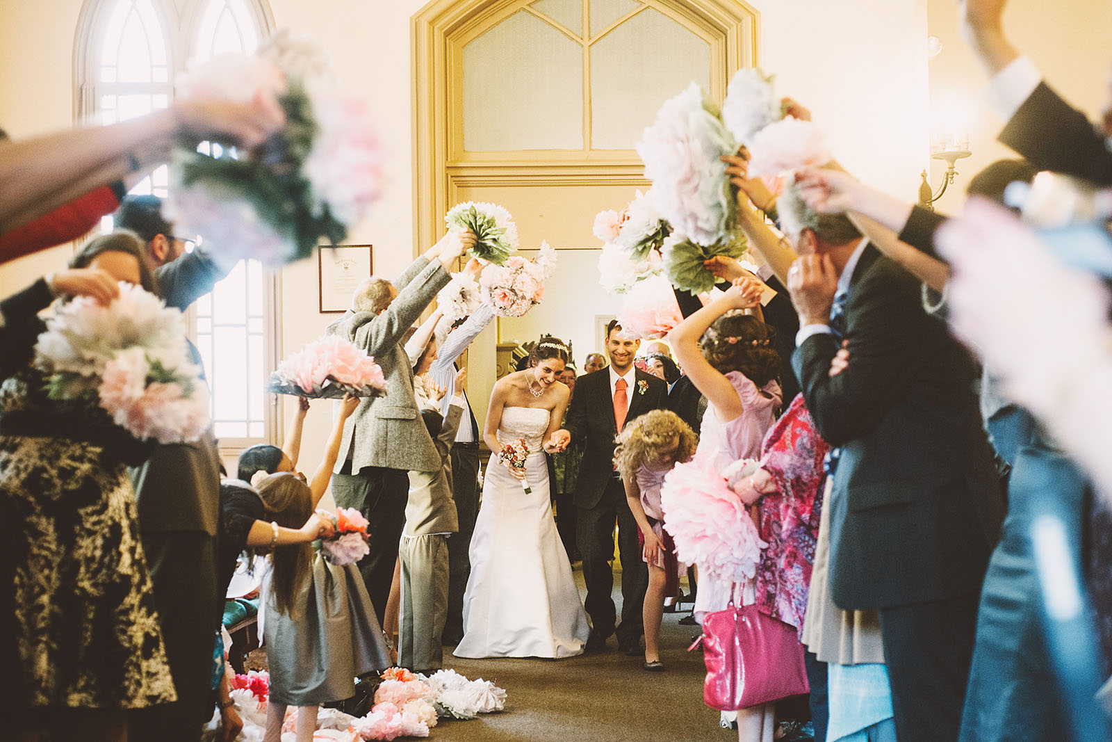 Bride and Groom's grand exit under paper flowers | Old Church Wedding Photos