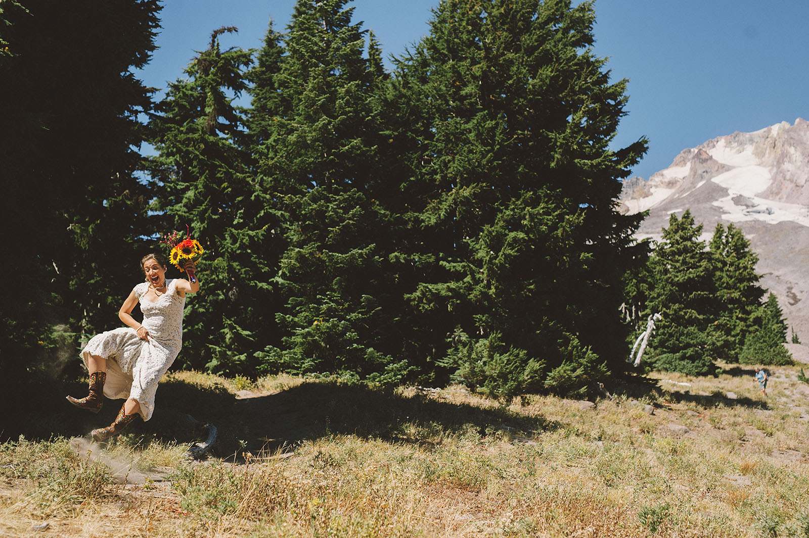 Bride jumping and clicking her heels together | Mazama Lodge Wedding