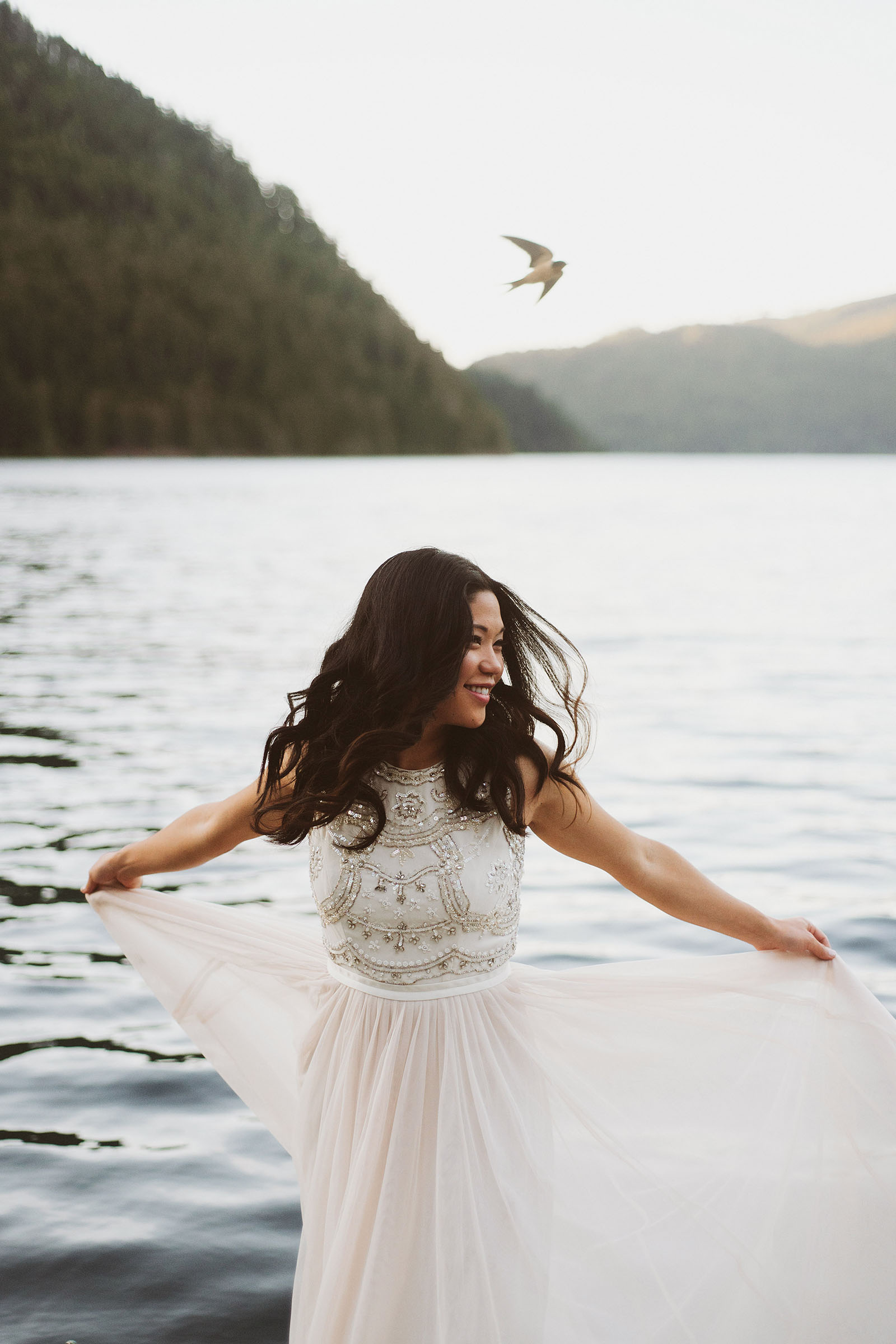 Portrait of bride spinning in her dress as a bird flies overhead | Olympic National Park Wedding