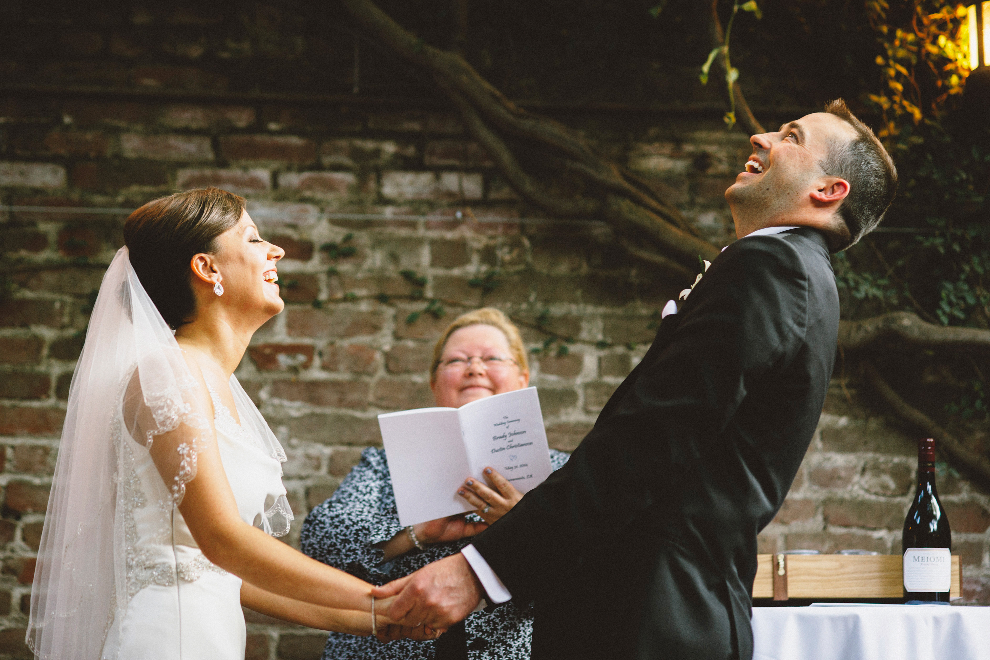 Bride and Groom laughing at the officiant | Sacramento Firehouse Wedding