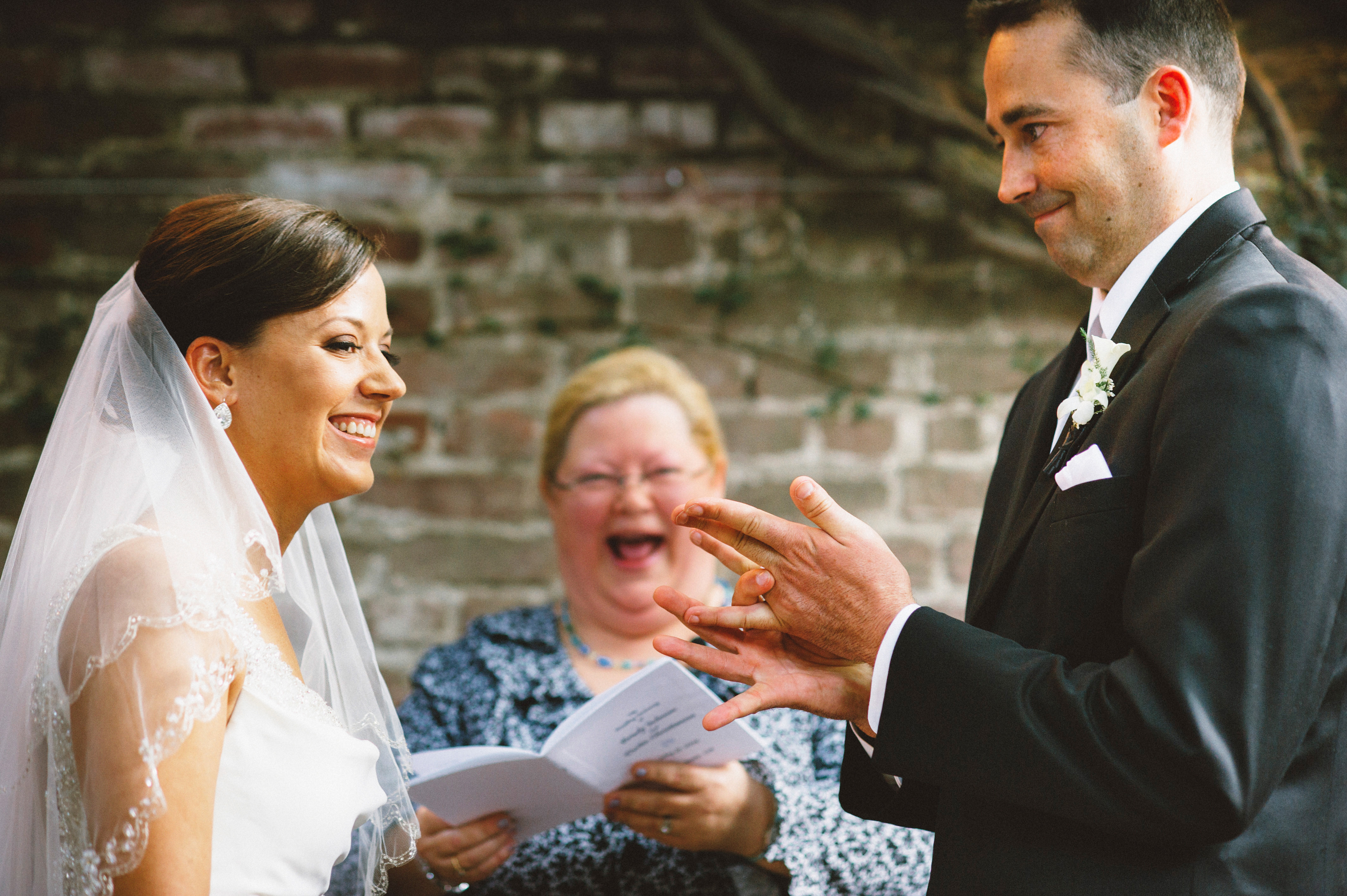 Groom shoving his ring on | Sacramento Firehouse Wedding