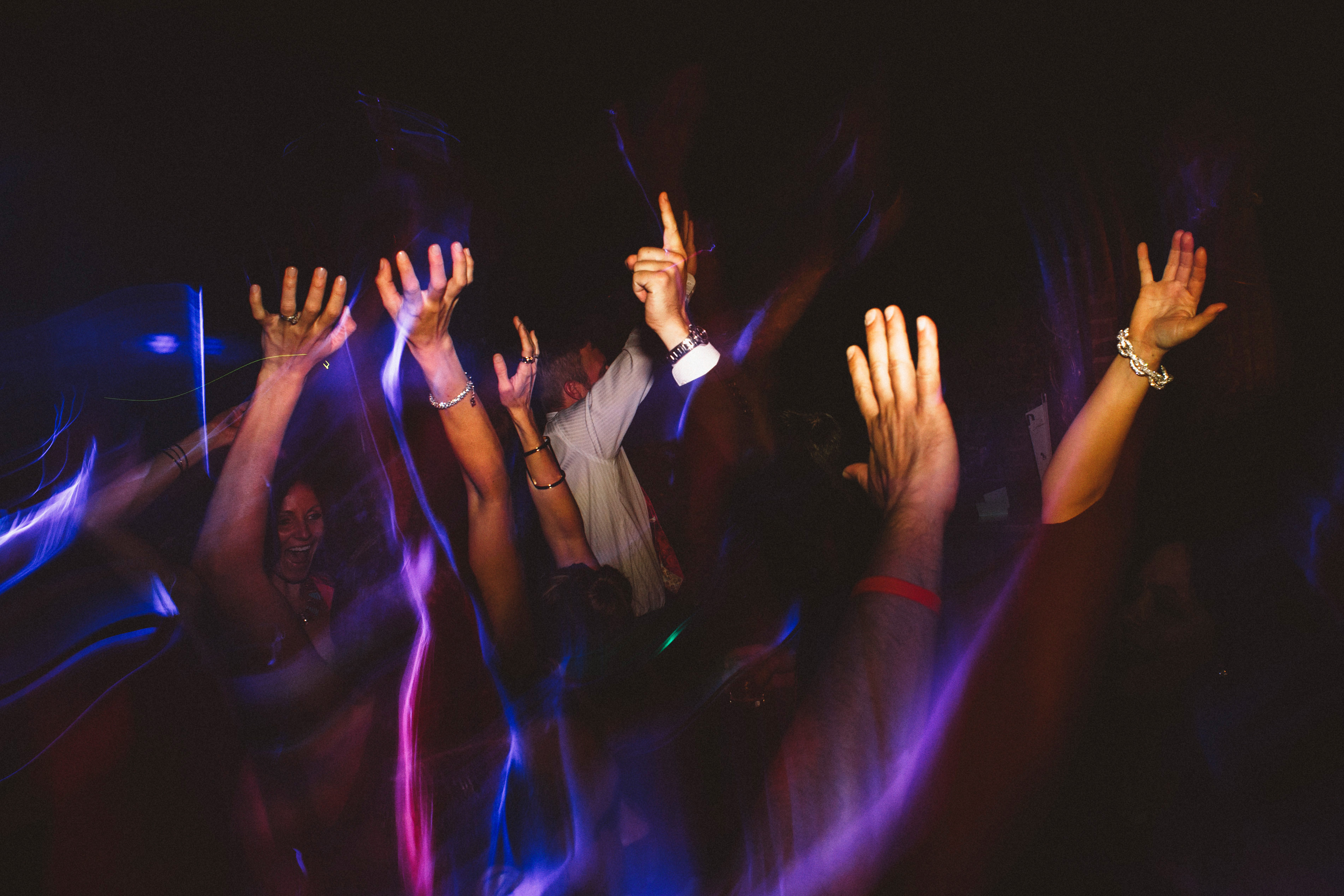 Hands in the air on the dance floor | Sacramento Firehouse Wedding