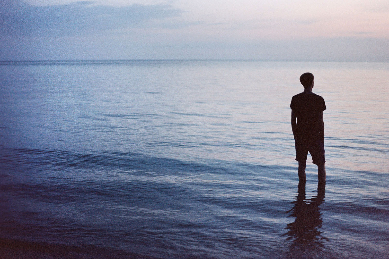 Silhouette standing in the ocean water at sunset | Thailand Travel Photos