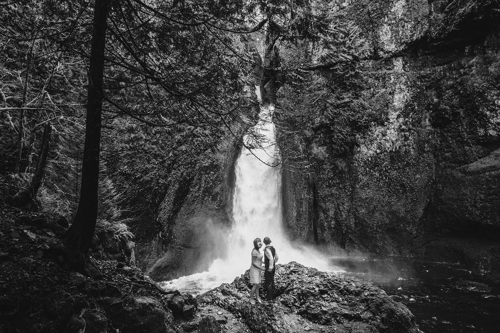 Brides hugging at ceremony site | Wahclella Falls Wedding