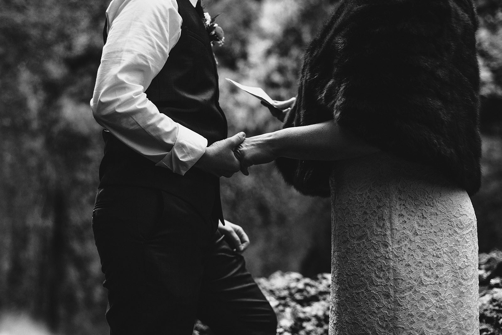 Brides holding hands during vows | Wahclella Falls Wedding