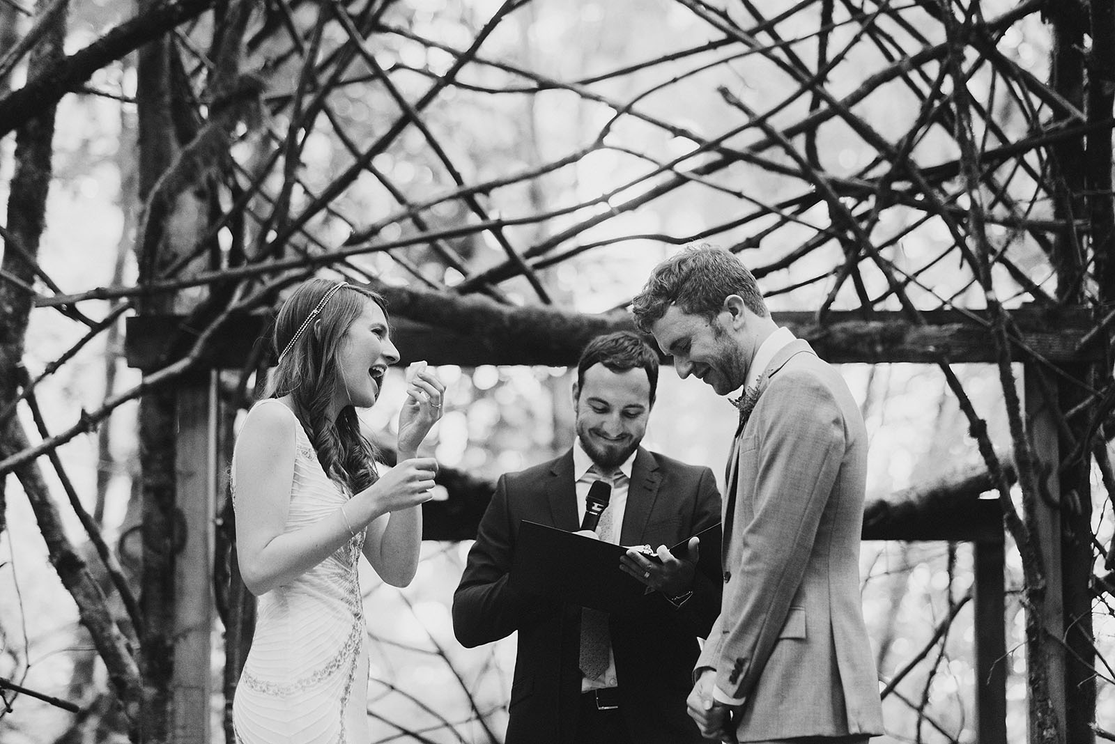 Bride wiping away a tear during the vows | Woodsy Campground Wedding