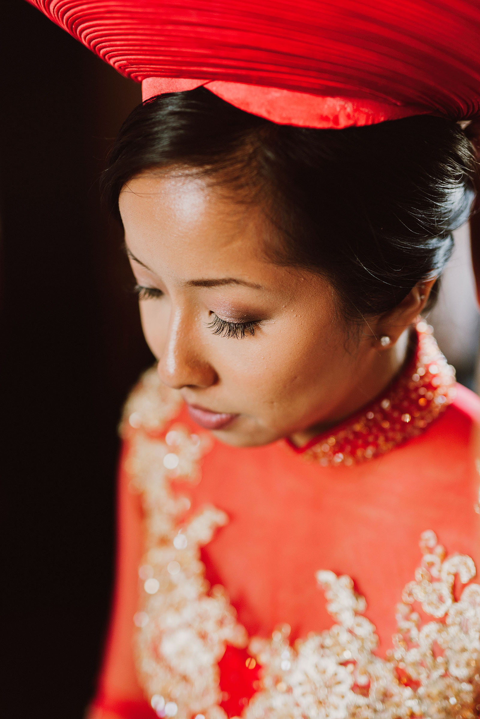Bride getting dressed in traditional Vietnamese gown and hat | Portland Castaway Wedding