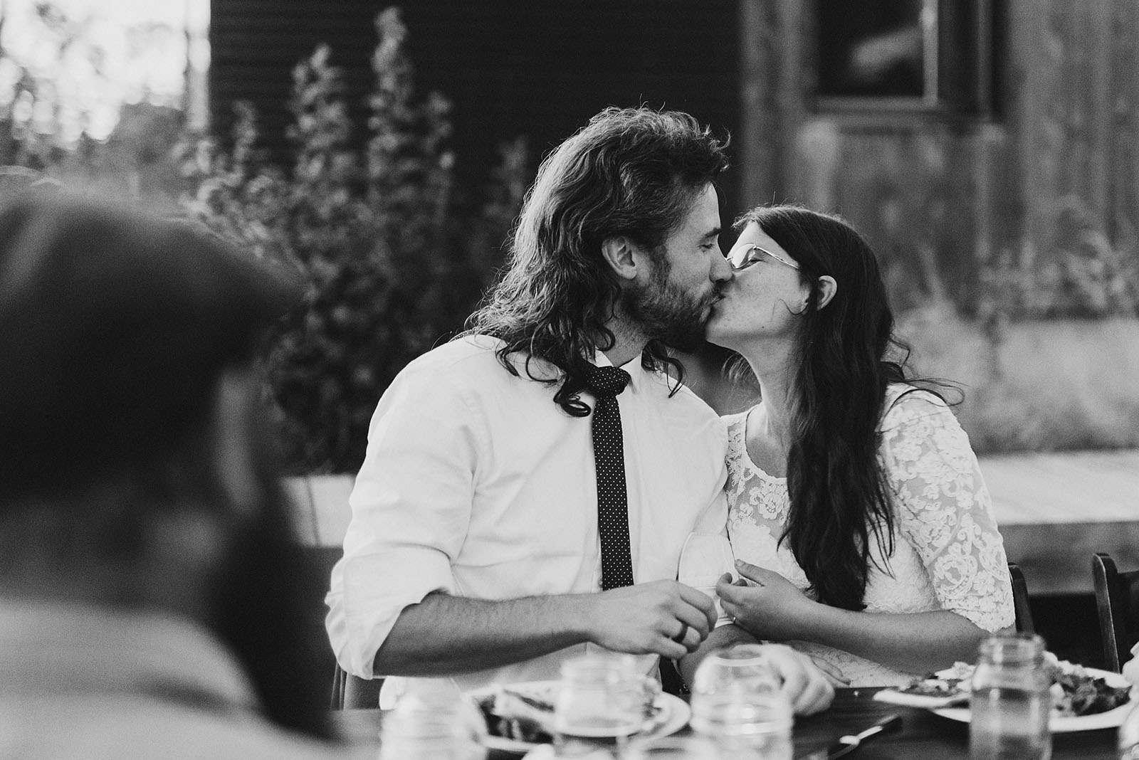 Bride and groom kissing at dinner | Sauvie Island Wedding