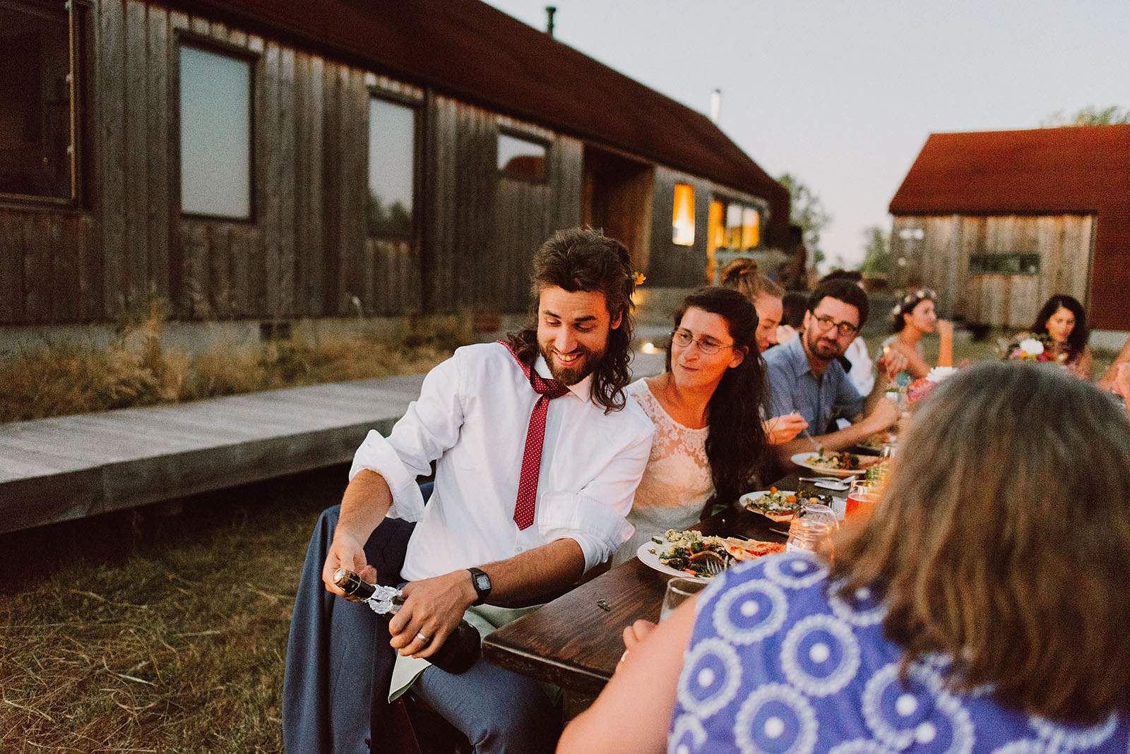 Groom popping a bottle of champagne | Sauvie Island Wedding