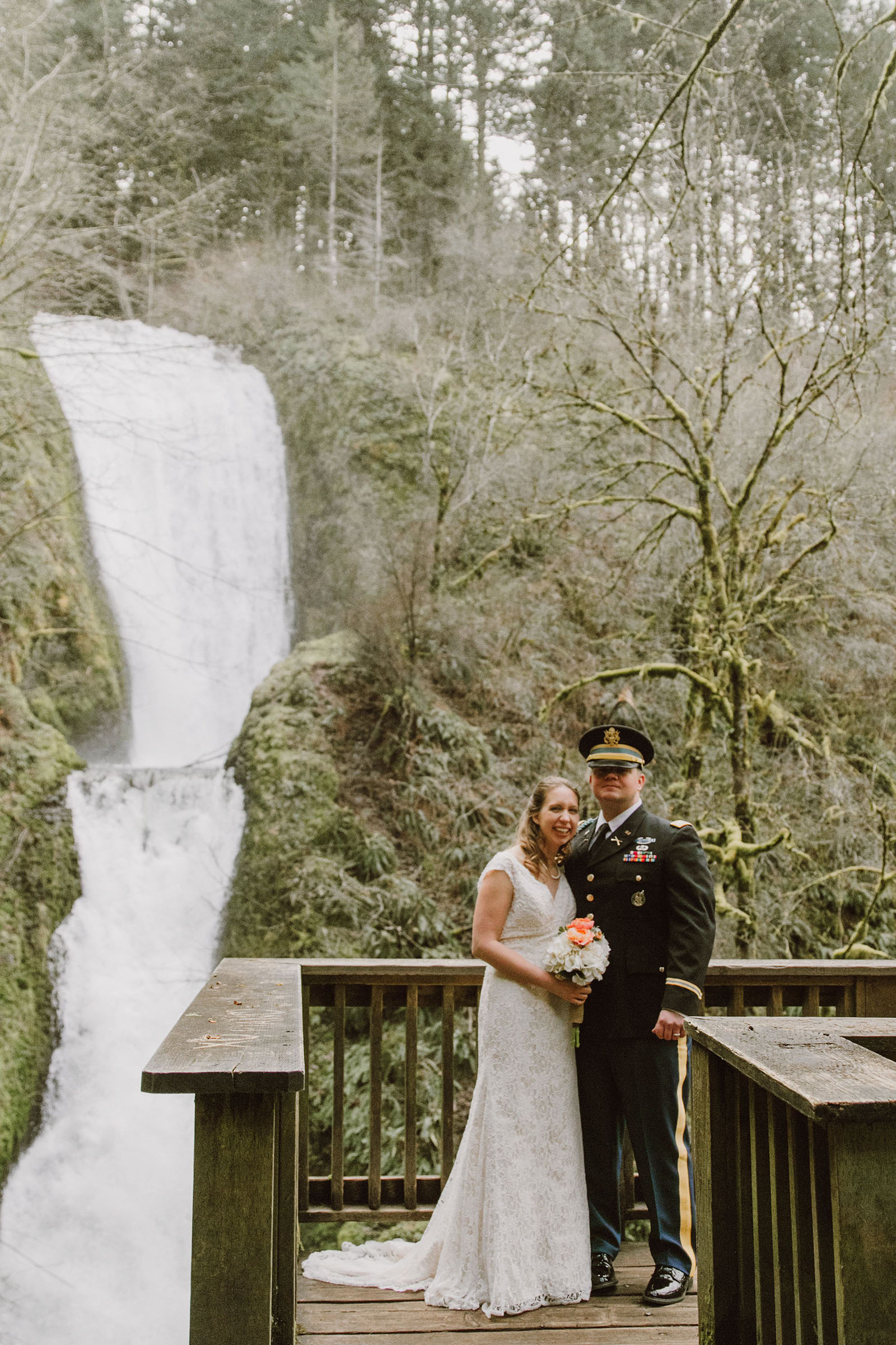 Bride and Groom posing in front of a waterfall | Bridal Veil Elopement Photographer