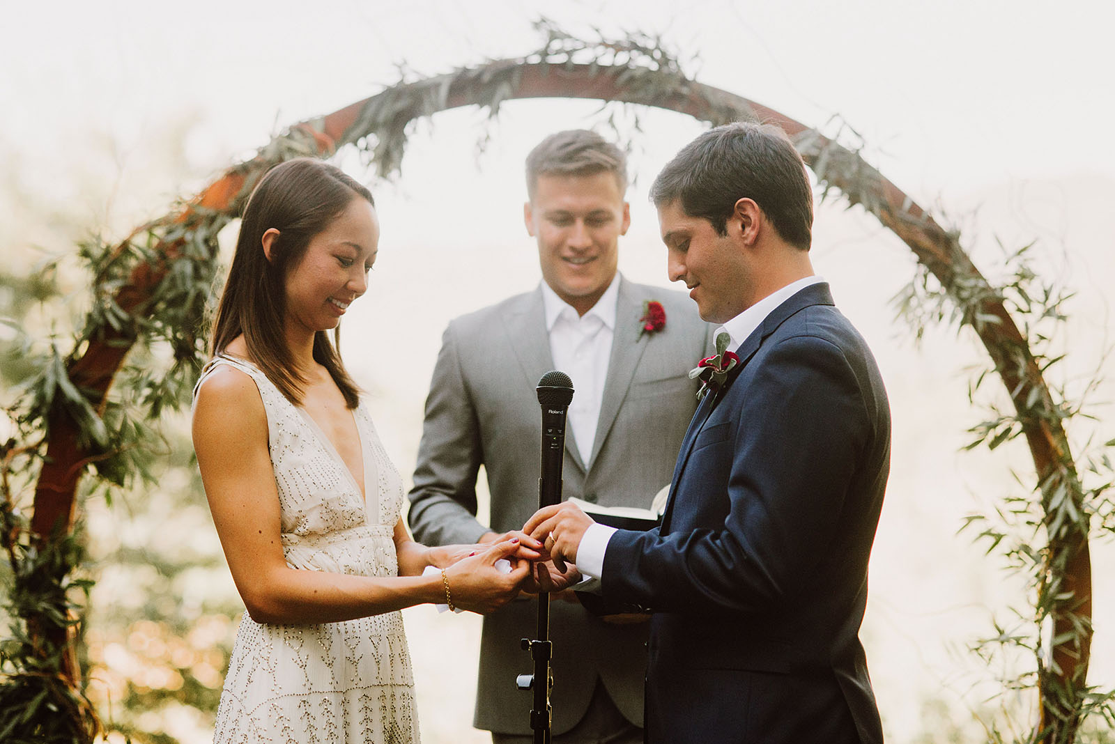 bride and groom exchanging rings at Sacred Mountain Retreat - Portland Wedding photography