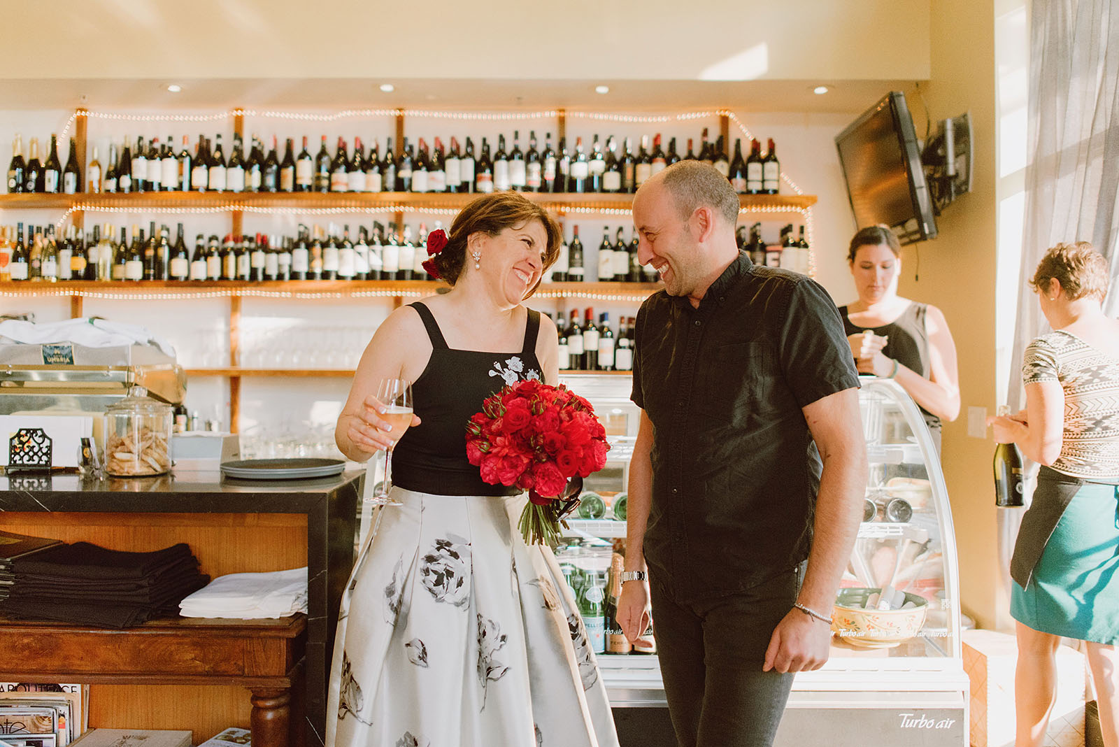 Bride laughing with restaurant owner