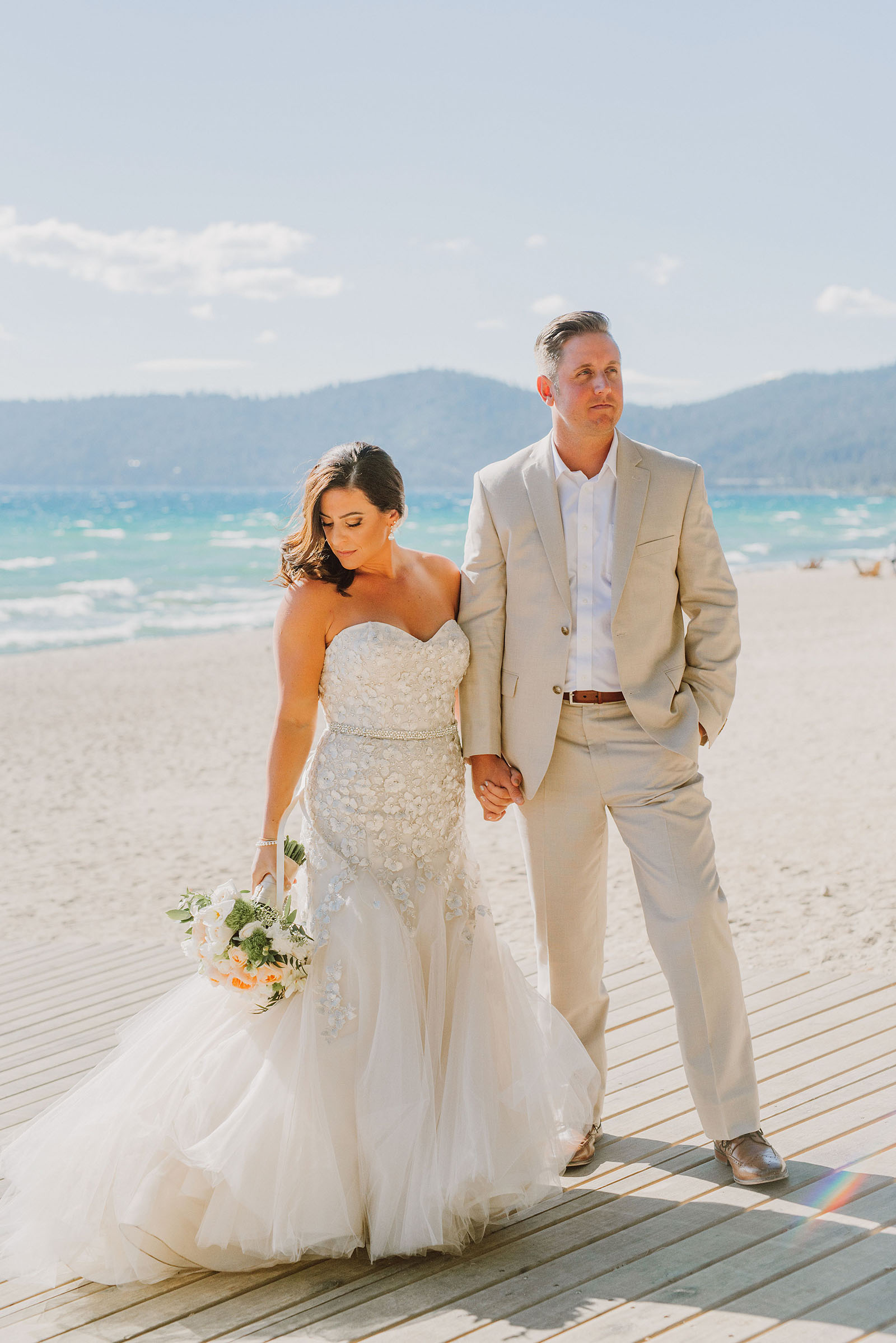 Bride and Groom posing on the North Lake Tahoe beach at an Incline Village wedding