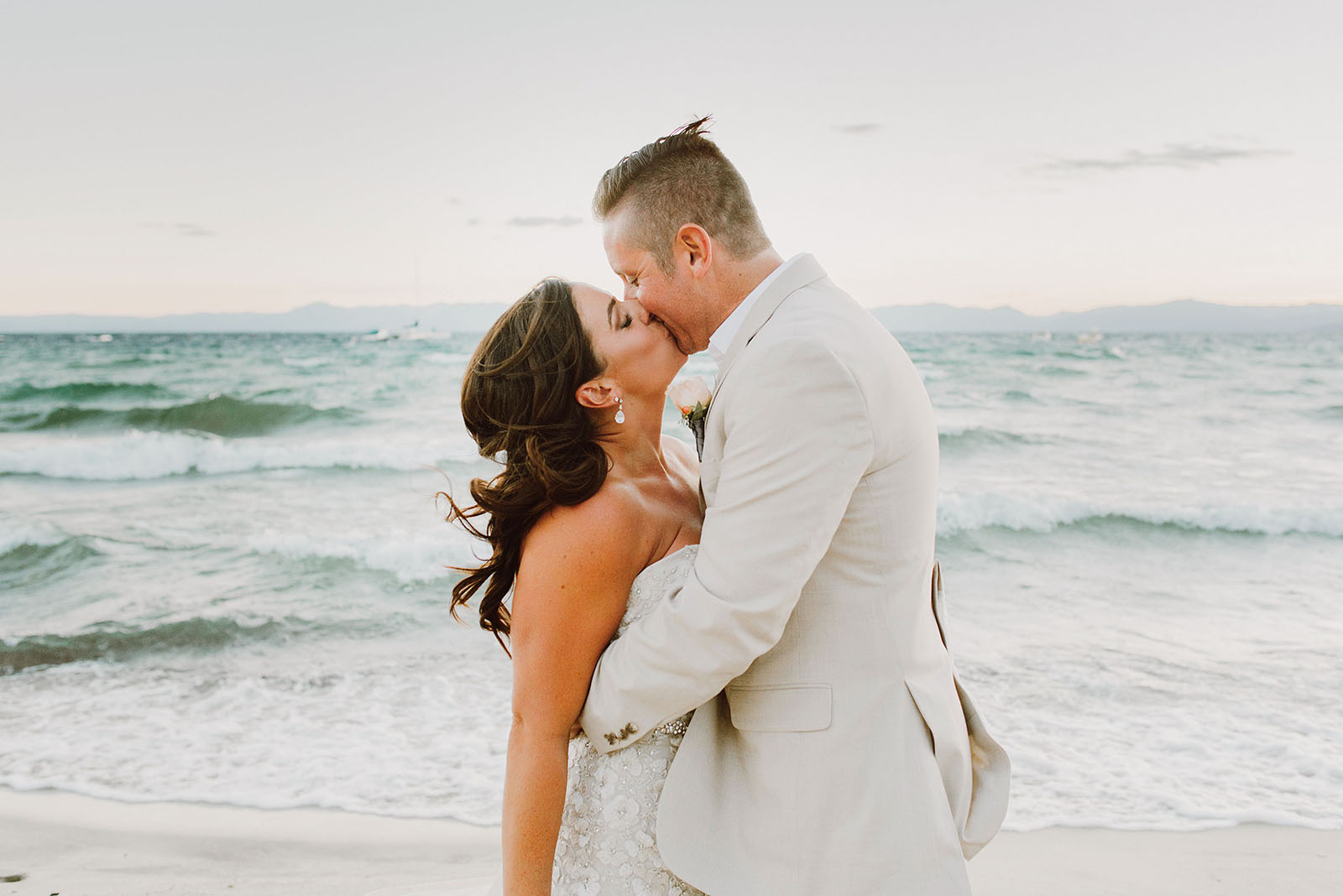 Bride and Groom kissing on the North Lake Tahoe beach at an Incline Village Wedding