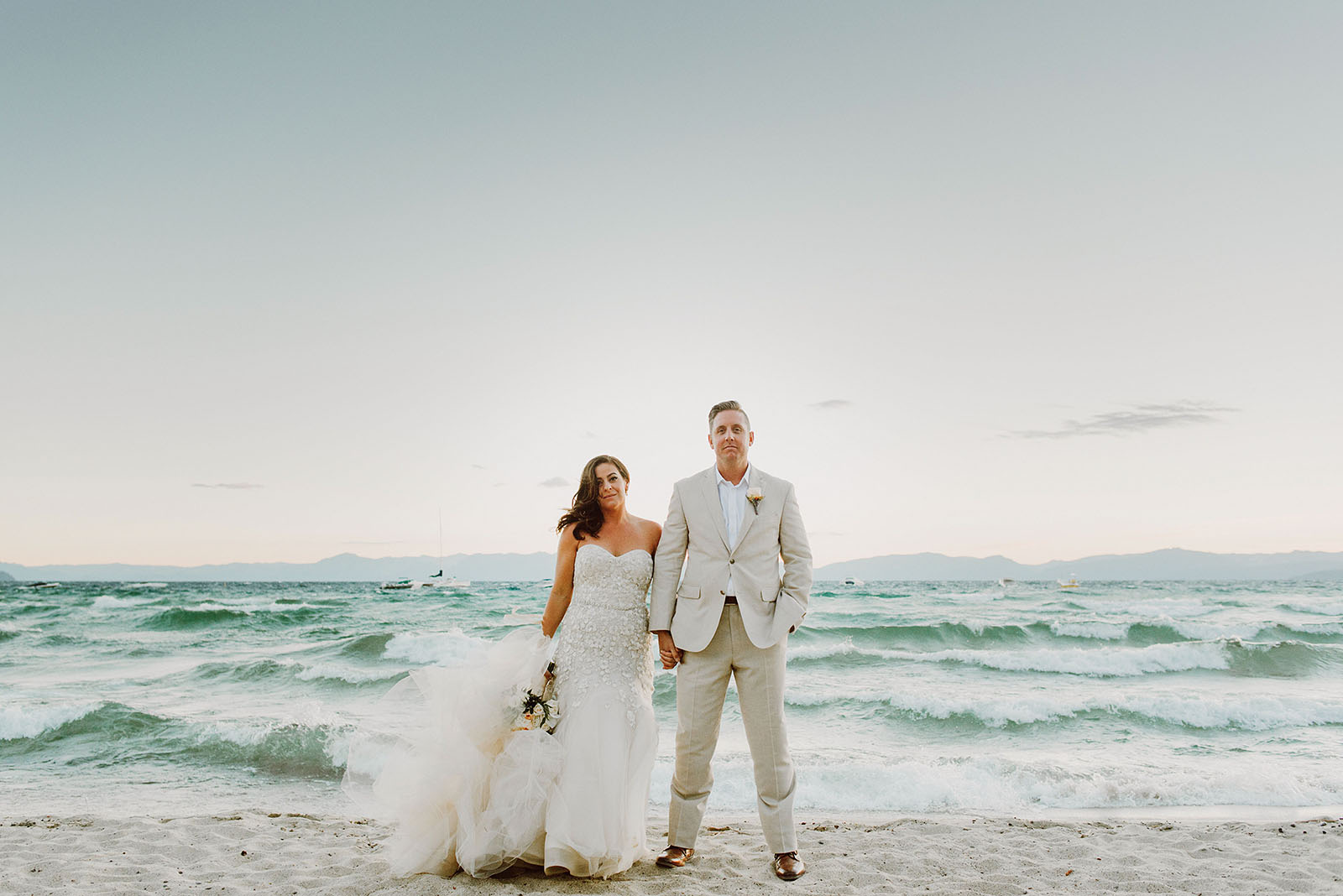 Waves crashing behind Bride and Groom at an Incline Village wedding