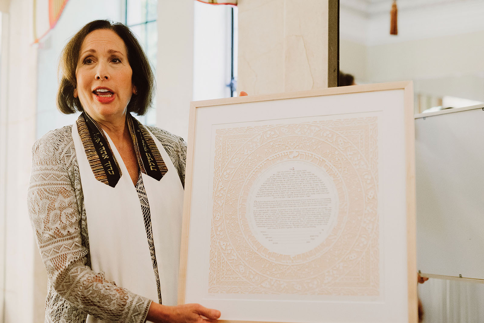 Cantor Ida Rae Cahana holding the Ketubah at a Congregation Beth Israel wedding